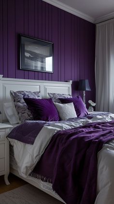 a bedroom with purple and white bedding in the corner, along with two nightstands