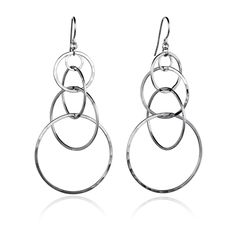 silver earrings on a white background with reflection in the foreground and an image of two circles