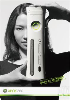 a woman holding up a video game controller in front of her face with the words xbox 360 on it