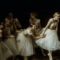 several ballerinas in white tutus are dancing together