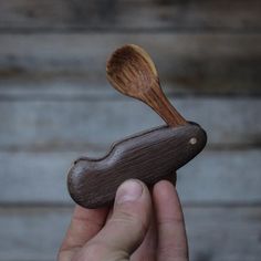 a person holding a wooden spoon in their hand