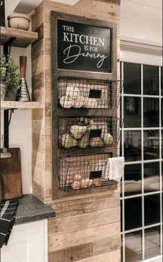 this kitchen is for baking with bread in baskets on the wall and shelves above it