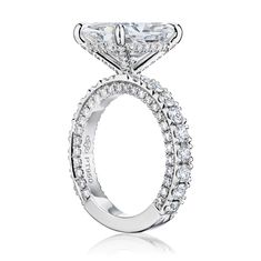 a princess cut diamond engagement ring set in 18k white gold with pave diamonds