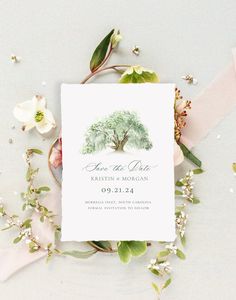 a wedding save the date card with an olive tree on it and flowers around it