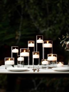 a table with candles and plates on it