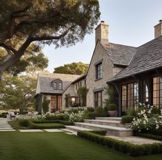 a large house with lots of windows and landscaping