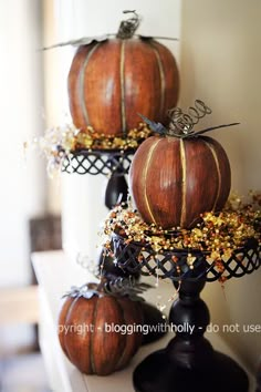 three pumpkins sitting on top of each other