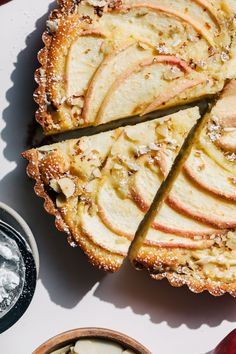 an apple pie with slices cut out on a plate