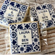 four decorated cookies sitting on top of each other in plastic wrappers with the words laura and ben printed on them