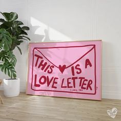 this is a love letter sign in front of a potted plant on the floor