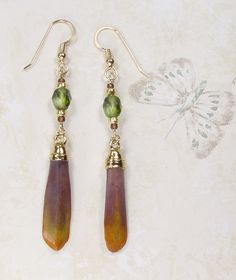 pair of earrings with green and brown beads