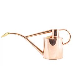 a metal watering can with a long handle and a gold spigot attached to it