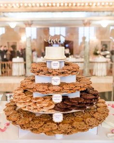 a wedding cake made out of cookies on top of a table