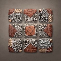 an art piece made out of different types of beads and leathers on a gray background