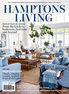 a living room filled with blue furniture and lots of window coverings on the cover of a magazine