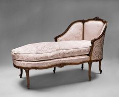 an old fashioned chaise lounge with pink upholstered fabric