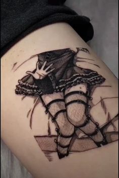 a woman's thigh with an artistic tattoo on it