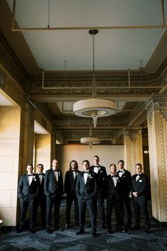 a group of men in tuxedos standing next to each other