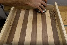 a man sanding wood with a mouse