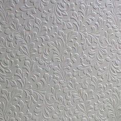 white textured wallpaper with an intricate design