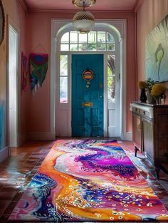 a brightly colored area rug is in front of a blue door with an ornate doorway