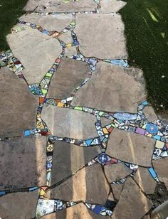 a walkway made out of different colored glass tiles