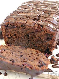 a loaf of chocolate cake sitting on top of a cutting board