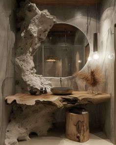 a bathroom with a sink, mirror and large rock formation on the wall next to it