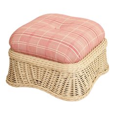 a wicker foot stool with a pink plaid cushion on it's seat cover