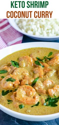 a white bowl filled with shrimp and coconut curry next to rice on a blue table cloth