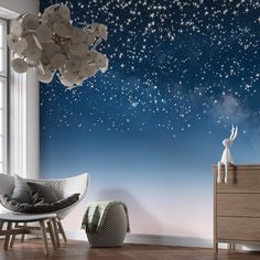 a room with a large window and stars painted on the wall, along with a white rocking chair