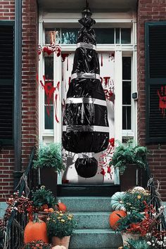 a large black christmas tree sitting in front of a building