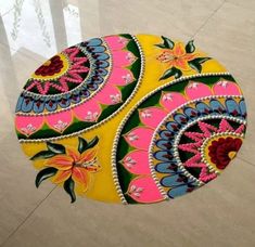 an artistically designed round rug on the floor