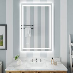 a bathroom with a sink, mirror and towel rack