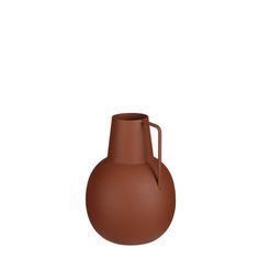 a brown vase sitting on top of a white surface