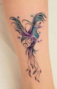 a colorful tattoo on the leg of a woman's leg with watercolors