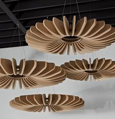 several wooden chandeliers hanging from the ceiling