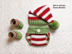 a crocheted hat, booties and diaper cover on a white surface