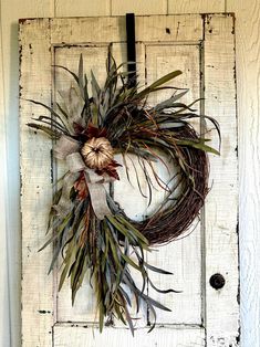 an old door with a wreath hanging on it