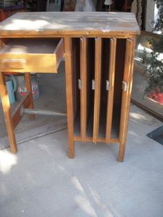 a wooden desk sitting on top of a cement floor