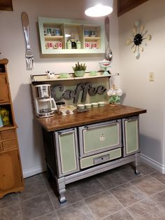 an old fashioned stove with the word coffee painted on it's front and side