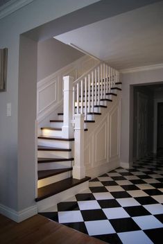 a staircase with black and white checkered flooring