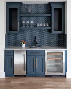 an image of a kitchen with blue cabinets and stainless steel appliances on the counter top