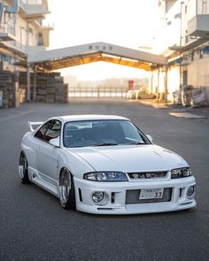 a white car parked in front of a building