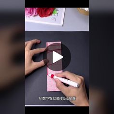 someone is making a card with pink paper