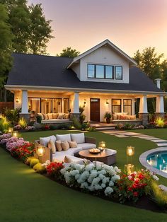 a house with a pool in the front yard and landscaping around it at night time