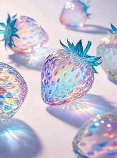 several glass strawberries are floating in the air with colorful lights around them and on top of each other