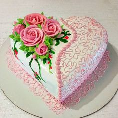 a heart shaped cake decorated with pink roses