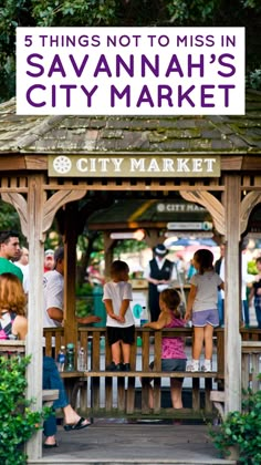 several people are gathered around a small wooden gazebo in the city market with a sign reading 5 things not to miss in savannah's city market