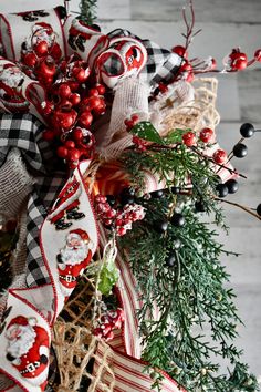 a christmas wreath with red berries and ornaments